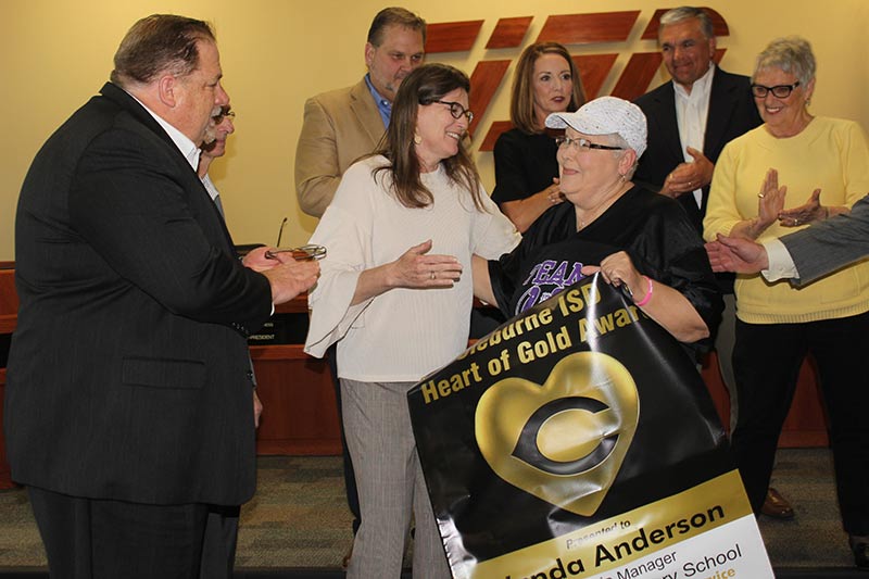 Superintendent Dr. Kyle Heath, left, joins with Trustees in congratulating Coleman Elementary Cafeteria Manager Wanda Anderson, the 2019 recipient of the Cleburne ISD Heart of Gold Award.