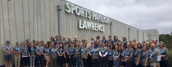 people pose in front of Sports Pavilion Lawrence