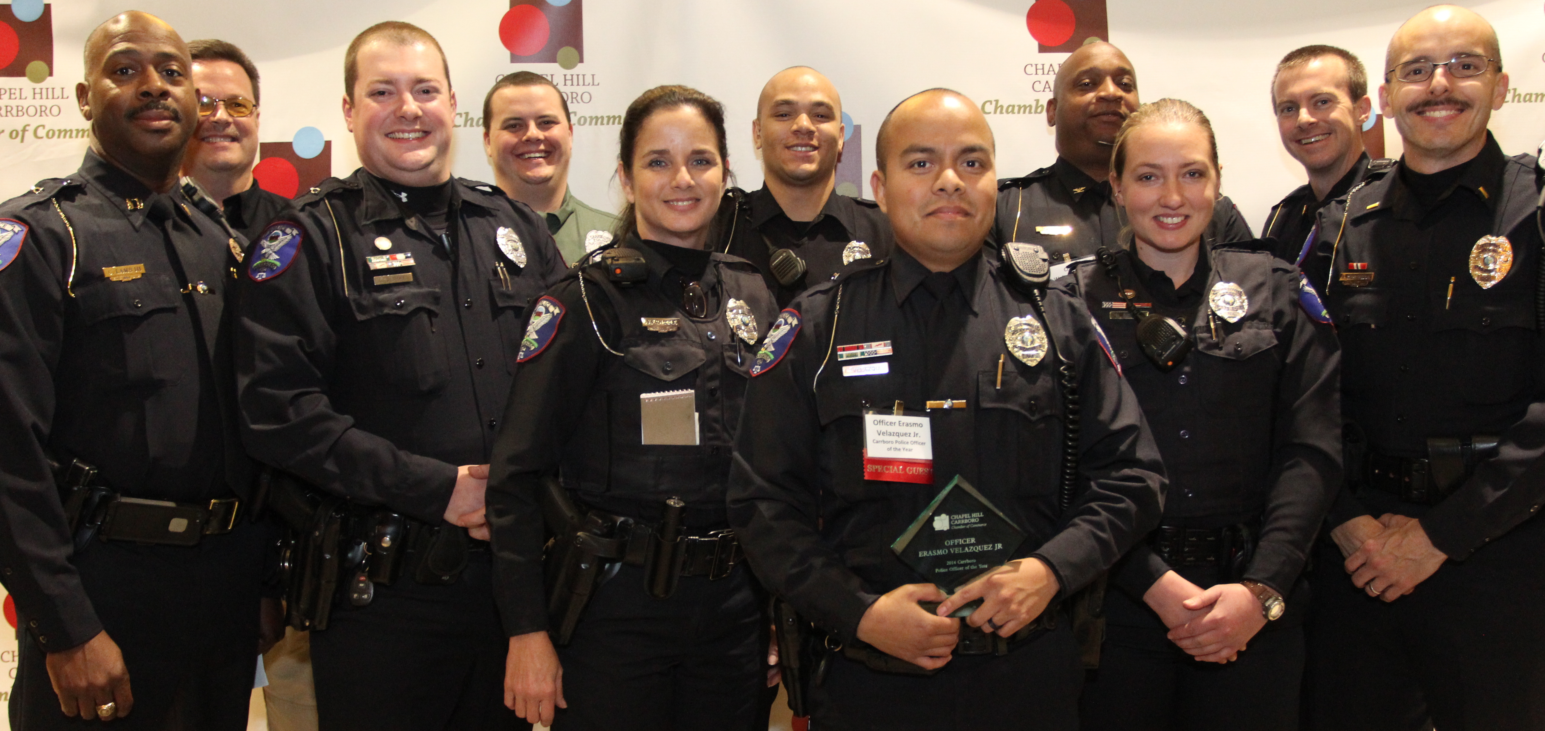 group of police officers smiling at camera in uniform