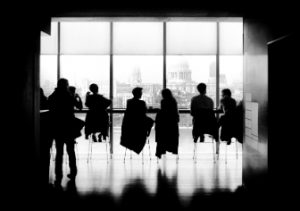 people in chairs in front of window