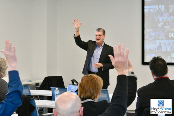 Ambassadors for Business president, Bob Willbanks, leads an interactive presentation at an event.