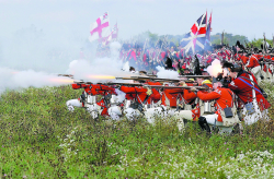 The Bristish troops fire during the 225th aniversary reenactment of the Battle of Saratoga Saturday afternoon on a farm in Ft. Edward. Saturday's battle was the Freeman's farm battle, and on Sunday the Bemis Heights battle will be fought.  (photo by Tom Killips)  10/12/2002