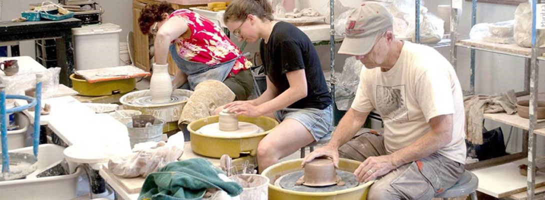 Pottery class students working on wheel