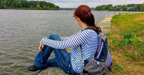 woman sitting by riverside