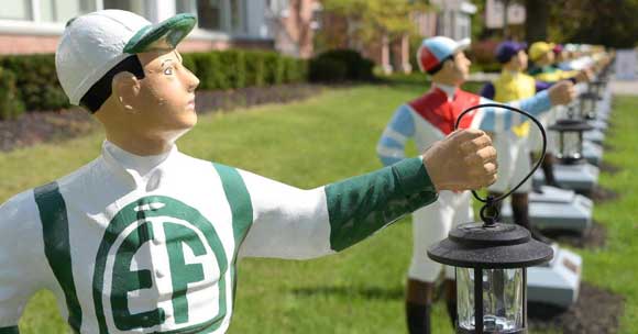 Statues of jockeys in a row