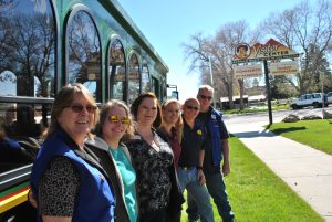 Members of Chamber staff and volunteers pose on a sunny day in front of the Visitor Center