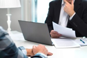 Banker considering an applicant for a loan to fund real estate