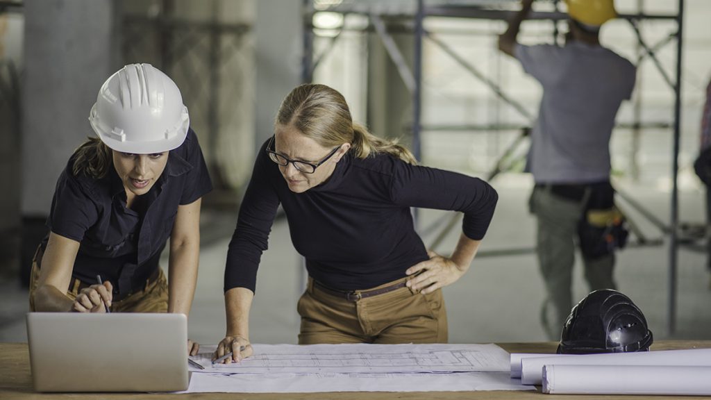 Architect and engineer discussing blueprints